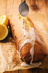 Homemade lemon bread on wooden background.