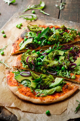 Vegan pizza with vegetables and pesto