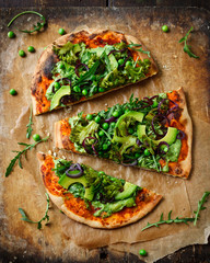 Vegan pizza with vegetables and pesto