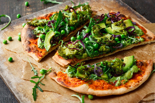 Vegan pizza with vegetables and pesto