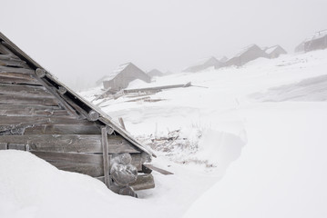 Abandon houses under snow and mist