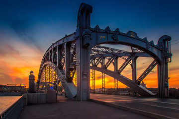 Beautiful sky against the backdrop of an old bridge. St. Petersburg. Bolsheokhtinsky Bridge.