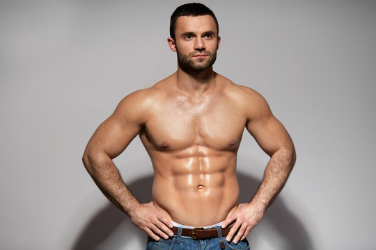 Handsome Smiling Young Man With Sexy Fit Muscular Body Indoors
