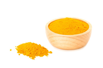 turmeric powder in wooden bowl