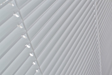White horizontal blinds on window, close-up