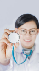 portrait of Asia women  doctor on plain background.Focus on Stethoscope Classic Cardiology