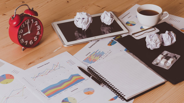 Bussiness concept, alram clock with tablet on wooden table.