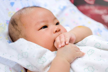 asian baby keep hand in the mouth