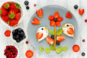 Summer food art for kids - edible picture on plate with fresh berries