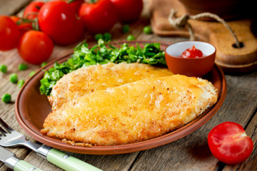 Turkey breast chops cutlets with cheese crust and fresh vegetable