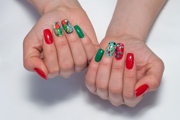 Bright festive red, green, mint, craquelure, multicolored, cracked, circles, shine, point manicure on long square nails on white background close-up 