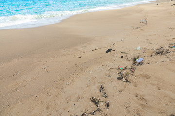 Plastic bottles and other waste on sea beach .
