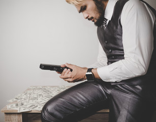 Money and power, Senior gangster with gun, in suit at the table.