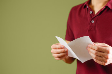 Man reading blank white flyer brochure. Read detailed booklet. Leaflet presentation. Pamphlet hold...