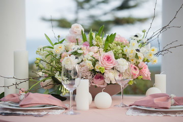 Beautiful wedding table that decorated with flower arrangements and candles.