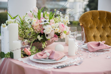 Beautiful wedding table that decorated with flower arrangements and candles.