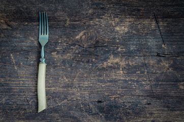 Rustic fork on old wooden shabby background
