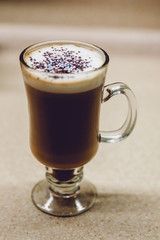 Coffee in the kitchen. We prepare coffee at home with our own hands. With caramel and colored powder.