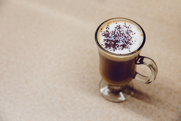 Coffee in the kitchen. We prepare coffee at home with our own hands. With caramel and colored powder.