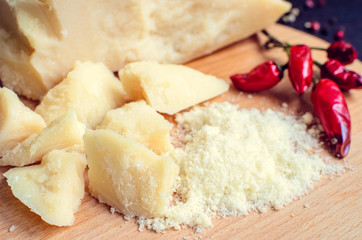 Grated Parmesan cheese on wooden board