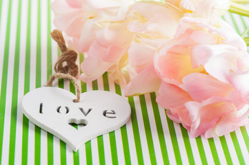 Pink tulips and wooden heart