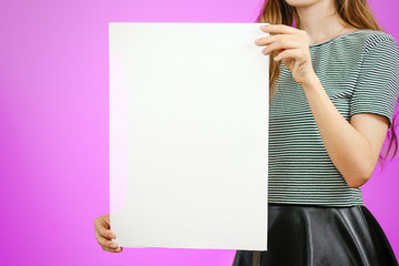 Woman showing blank white big A2 paper. Leaflet presentation. Pamphlet hold hands. Girl show clear...
