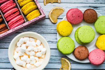Still life with cup of tea and sweets on the wooden background