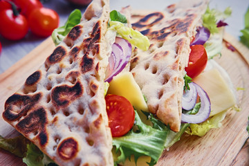 Pita bread with ham, cucumber and tomatoes.