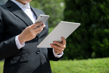 woman holding smart phone and tablet PC 