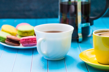 Still life with cup of tea and sweets on the wooden background