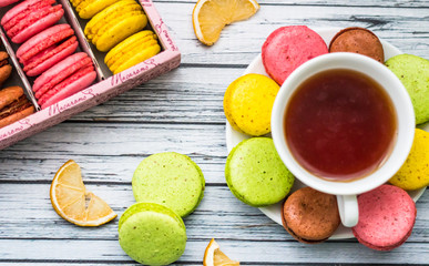 Still life with cup of tea and sweets on the wooden background