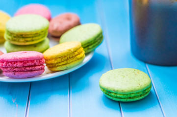 Still life with cup of tea and sweets on the wooden background