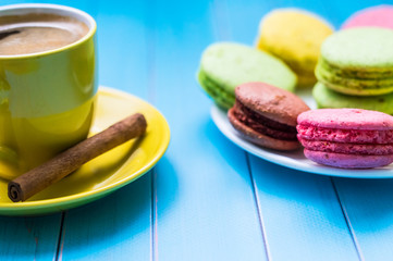 Still life with cup of tea and sweets on the wooden background