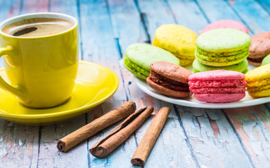 Still life with cup of tea and sweets on the wooden background