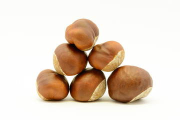 Closeup chestnuts isolated on white background. Fresh autumn chestnut. Sweet natural fruit the chestnut tree. Sign of autumn. Autumn decoration from chestnuts.