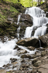 Obraz premium Waterfall in the mountains. Early spring in the Carpathians Ukraine. Travel.