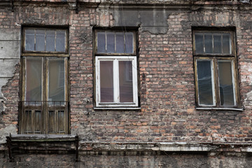 the facade of the old abandoned house with windows and door