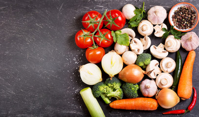 fresh vegetables for cooking on dark table