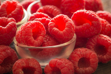 raspberries on the wooden background.