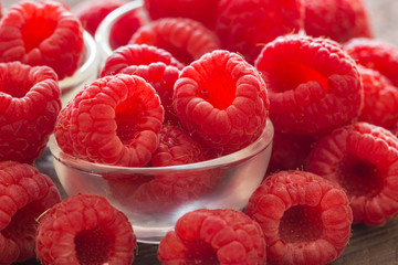 raspberries on the wooden background.