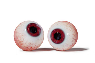 two realistic human eyeballs with red iris isolated on white background