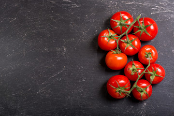 fresh tomatoes on dark table