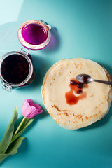 Russian pancakes with cherry jam for breakfast