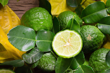 fresh bergamot and Yellow leaves on old wooden tables background