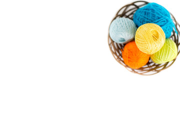 Balls of thread and wool in baskets background, isolated