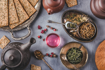 Variety of green and rosebud teas, crispy bread slices and clay teapots