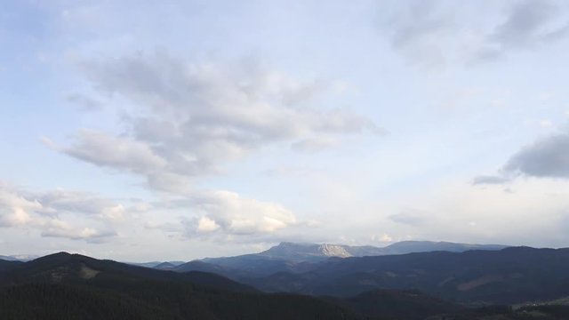 Panoramic landscape time lapse of sky and clouds and mountains.