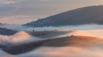 Church on the hill in foggy morning. Carpathians, Ukraine