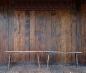 Old grunged long chair with wooden wall and floor