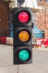 Confusing set of traffic lights showing red amber and green all at the same time can be used for concepts showing indecision mixed messages or conflicting signals
